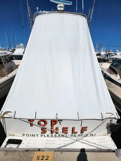 Top Shelf Yacht Photos Pics 1996 Cabo 35 Flybridge Sportfisher docked, covered, with "Top Shelf" text, Point Pleasant Beach, NJ.