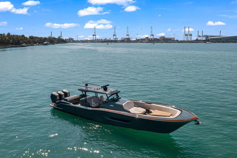  Yacht Photos Pics 2025 Buddy Davis PININFARINA 47 CC boat on calm water, industrial skyline in background.