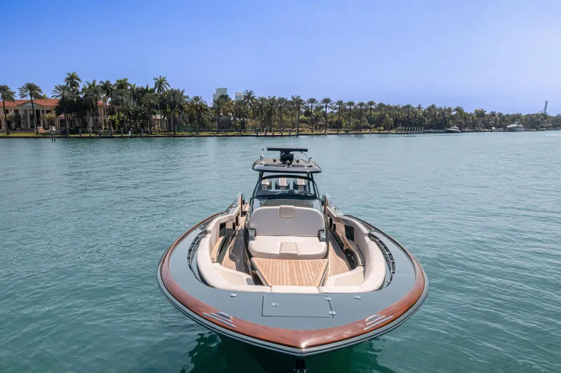  Yacht Photos Pics 2025 Buddy Davis PININFARINA 47 CC yacht on serene water with palm trees in background.