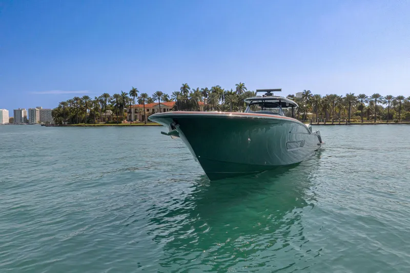  Yacht Photos Pics 2025 Buddy Davis PININFARINA 47 CC yacht on serene water with palm trees.