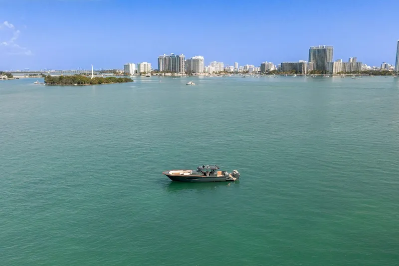  Yacht Photos Pics Boat on calm water with city skyline; 2025 Buddy Davis PININFARINA 47 CC.