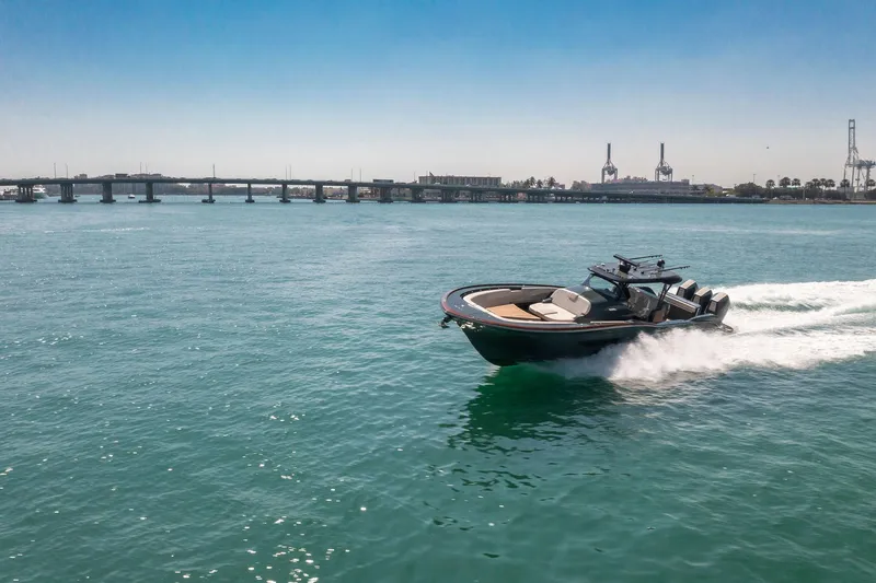  Yacht Photos Pics 2025 Buddy Davis PININFARINA 47 CC cruising on open water, bridge in background.