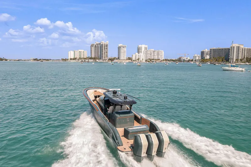  Yacht Photos Pics 2025 Buddy Davis PININFARINA 47 CC boat cruising in sunny coastal waters.