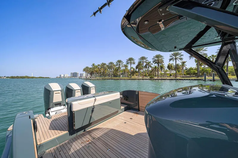  Yacht Photos Pics 2025 Buddy Davis PININFARINA 47 CC yacht on serene water with palm trees.