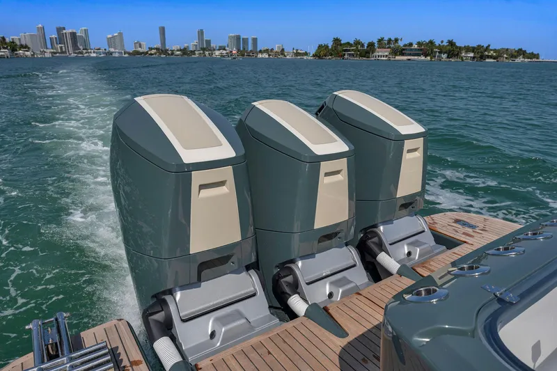  Yacht Photos Pics Triple outboard motors on 2025 Buddy Davis PININFARINA 47 CC, cruising near city skyline.