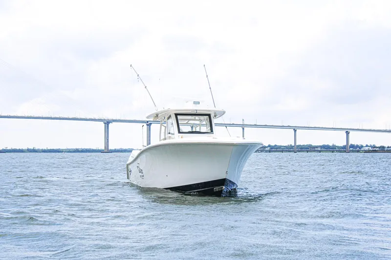  Yacht Photos Pics 2024 Blackwater 43 Sportfish boat on water with bridge in background.