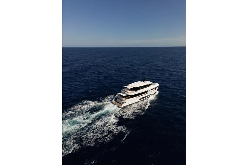  Yacht Photos Pics 2025 Ferretti Yachts INFYNITO 90 cruising on open sea under clear blue sky.