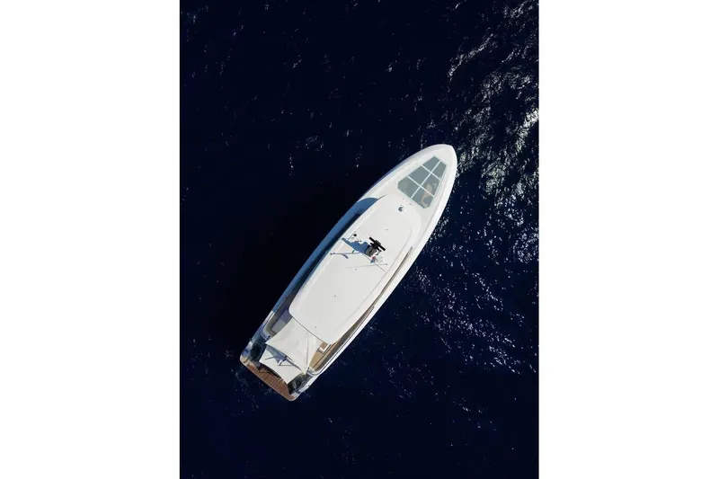  Yacht Photos Pics Aerial view of 2025 Ferretti Yachts INFYNITO 90 cruising on deep blue ocean.
