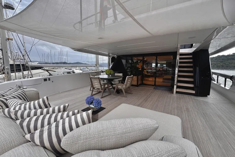  Yacht Photos Pics Luxurious deck of 2025 Ferretti Yachts INFYNITO 90 with elegant seating and dining area.