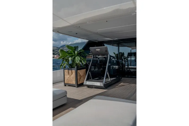  Yacht Photos Pics Luxurious 2025 Ferretti Yachts INFYNITO 90 with treadmill and plants on deck.