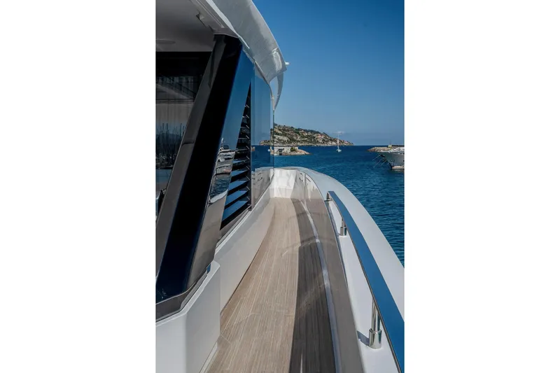  Yacht Photos Pics 2025 Ferretti Yachts INFYNITO 90, sleek deck view, ocean backdrop.