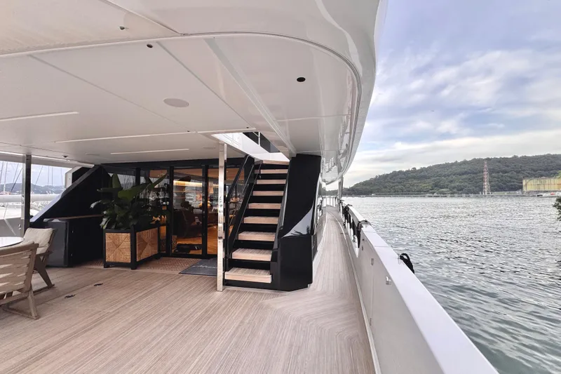  Yacht Photos Pics Luxurious 2025 Ferretti Yachts INFYNITO 90 deck with elegant seating and scenic water view.