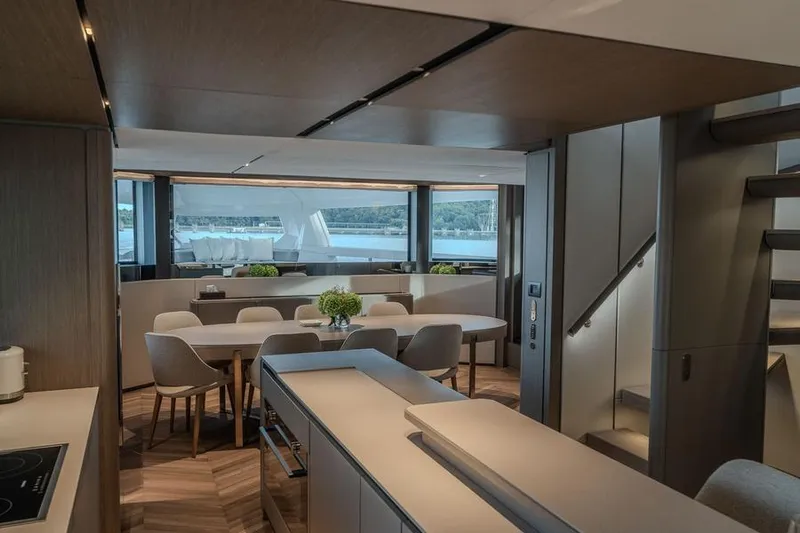  Yacht Photos Pics Luxurious interior of 2025 Ferretti Yachts INFYNITO 90, featuring elegant dining area and scenic views.