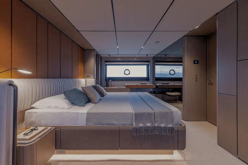  Yacht Photos Pics Luxurious bedroom interior of 2025 Ferretti Yachts INFYNITO 90, featuring modern design and elegant furnishings.