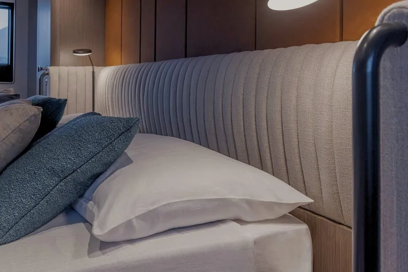  Yacht Photos Pics Luxurious bedroom interior on 2025 Ferretti Yachts INFYNITO 90, featuring elegant bedding and lighting.