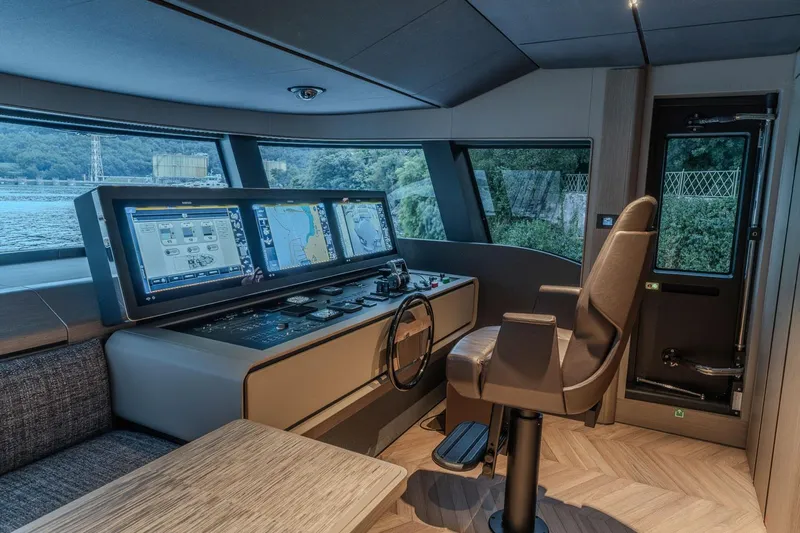  Yacht Photos Pics Luxurious helm of 2025 Ferretti Yachts INFYNITO 90 with advanced navigation systems.