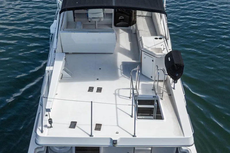  Yacht Photos Pics 2001 Bayliner 4788 Pilot House Motoryacht, spacious deck view, moored on calm water.