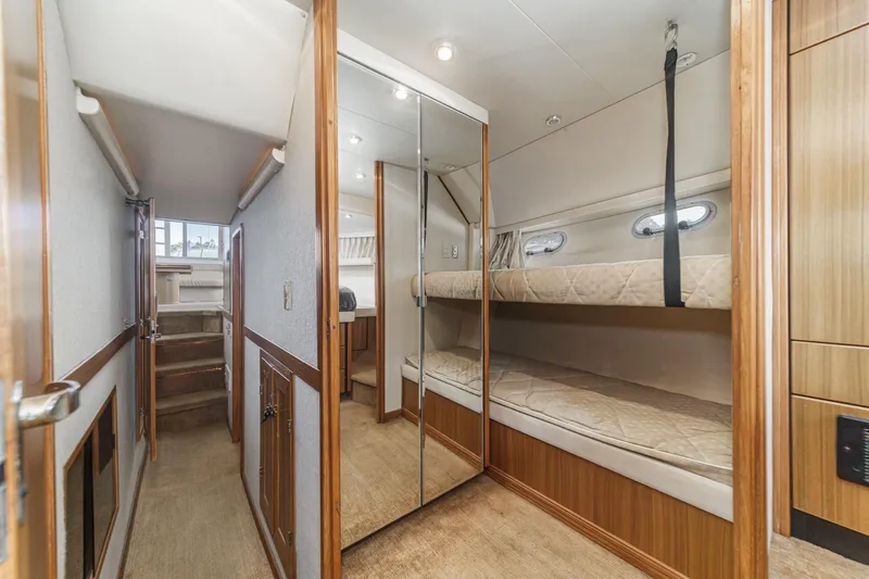  Yacht Photos Pics 2001 Bayliner 4788 Pilot House Motoryacht interior with bunk beds and mirrored closet.