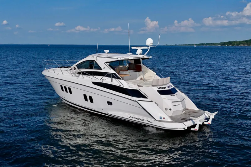Makin' Waves II Yacht Photos Pics 2011 Regal 52 Sport Coupe yacht cruising on open water under a clear sky.