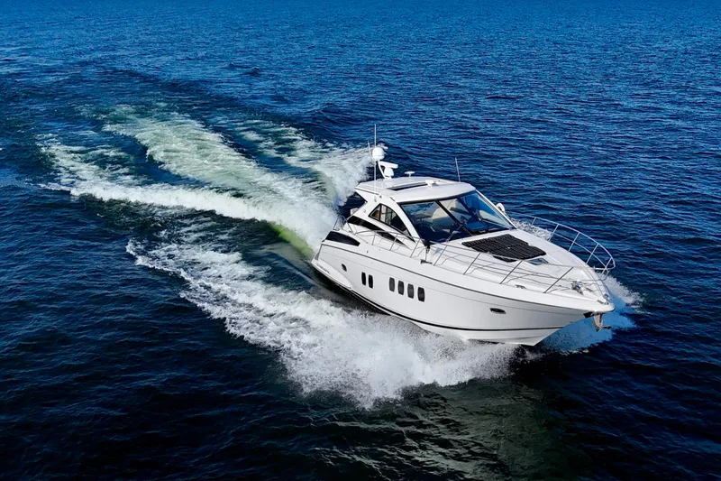 Makin' Waves II Yacht Photos Pics 2011 Regal 52 Sport Coupe cruising on open blue waters.