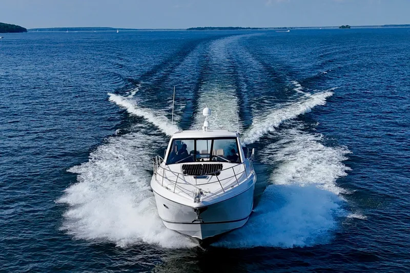 Makin' Waves II Yacht Photos Pics 2011 Regal 52 Sport Coupe cruising on open water, leaving a wake behind.