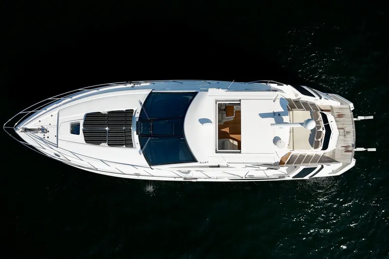 Makin' Waves II Yacht Photos Pics Aerial view of 2011 Regal 52 Sport Coupe yacht on dark water.