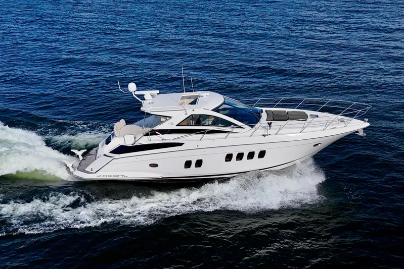 Makin' Waves II Yacht Photos Pics 2011 Regal 52 Sport Coupe cruising on open water, side view.