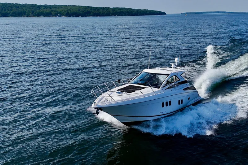 Makin' Waves II Yacht Photos Pics 2011 Regal 52 Sport Coupe cruising on open water, creating a dynamic wake.