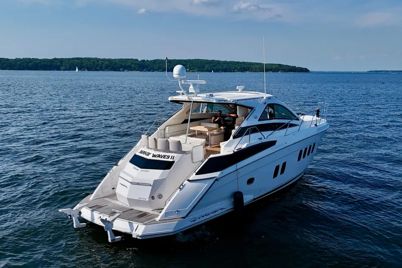 Makin' Waves II Yacht Photos Pics 2011 Regal 52 Sport Coupe yacht cruising on a serene lake.