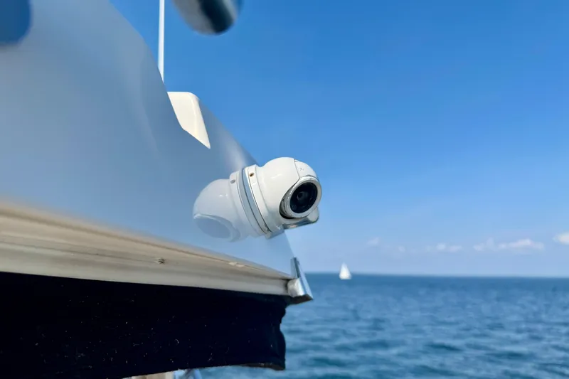 Makin' Waves II Yacht Photos Pics Security camera on 2011 Regal 52 Sport Coupe yacht, overlooking ocean under clear blue sky.