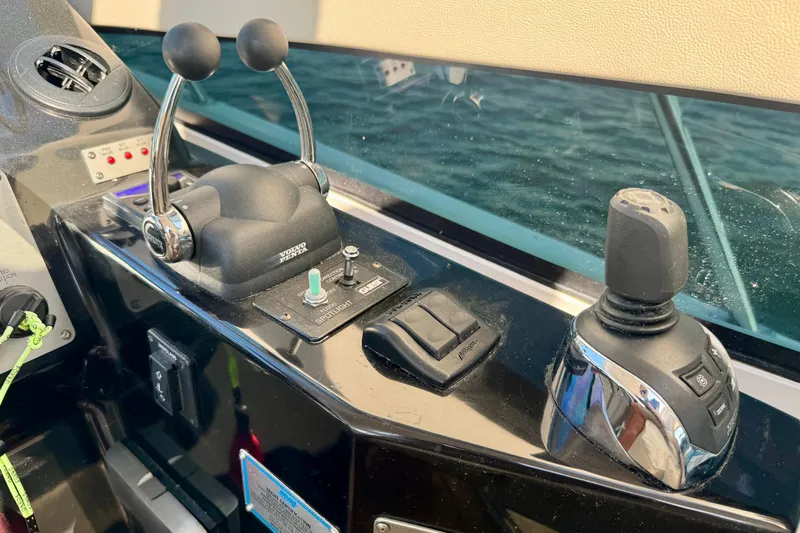 Makin' Waves II Yacht Photos Pics Control panel of a 2011 Regal 52 Sport Coupe boat with throttle and joystick.