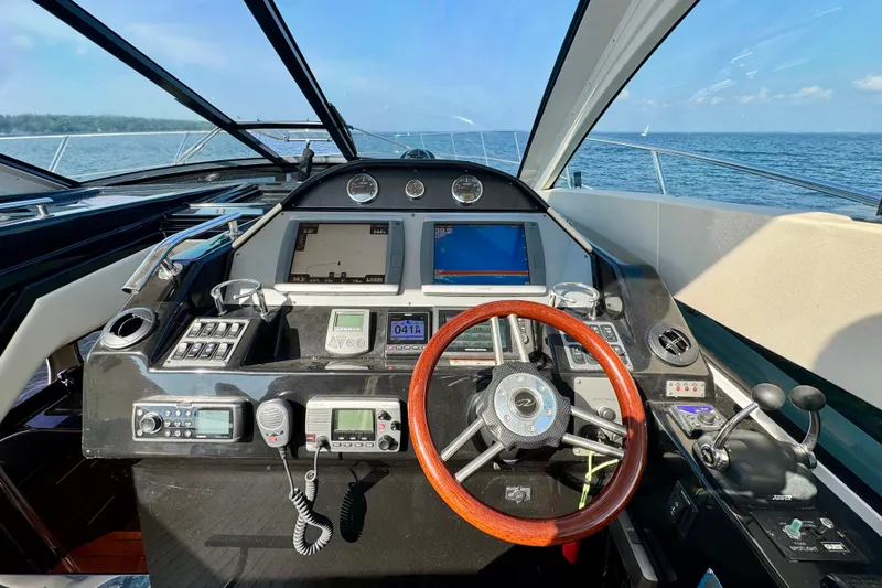 Makin' Waves II Yacht Photos Pics Cockpit of 2011 Regal 52 Sport Coupe yacht with advanced navigation controls and ocean view.