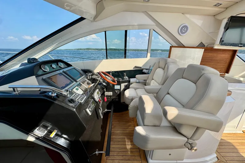 Makin' Waves II Yacht Photos Pics Interior of 2011 Regal 52 Sport Coupe yacht with luxurious seating and modern dashboard.