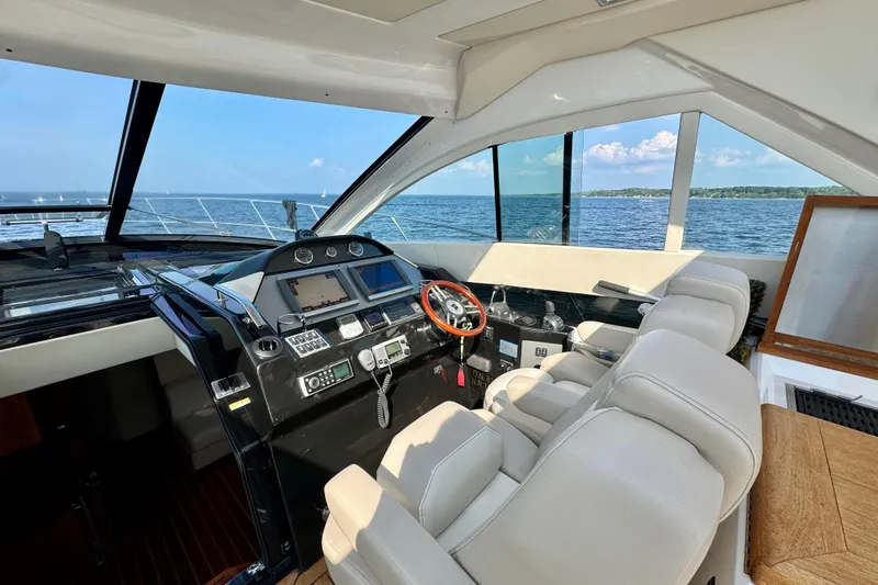 Makin' Waves II Yacht Photos Pics Interior cockpit of 2011 Regal 52 Sport Coupe yacht with modern controls and ocean view.