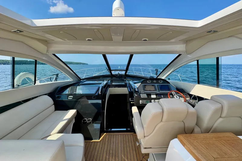 Makin' Waves II Yacht Photos Pics Interior view of 2011 Regal 52 Sport Coupe yacht, featuring luxurious seating and modern dashboard.