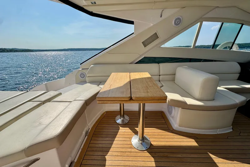 Makin' Waves II Yacht Photos Pics Luxurious 2011 Regal 52 Sport Coupe yacht interior with elegant seating and wooden table.