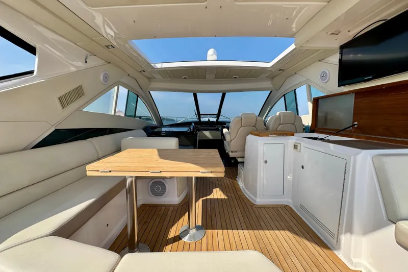 Makin' Waves II Yacht Photos Pics Luxurious interior of a 2011 Regal 52 Sport Coupe yacht with elegant seating and wooden flooring.