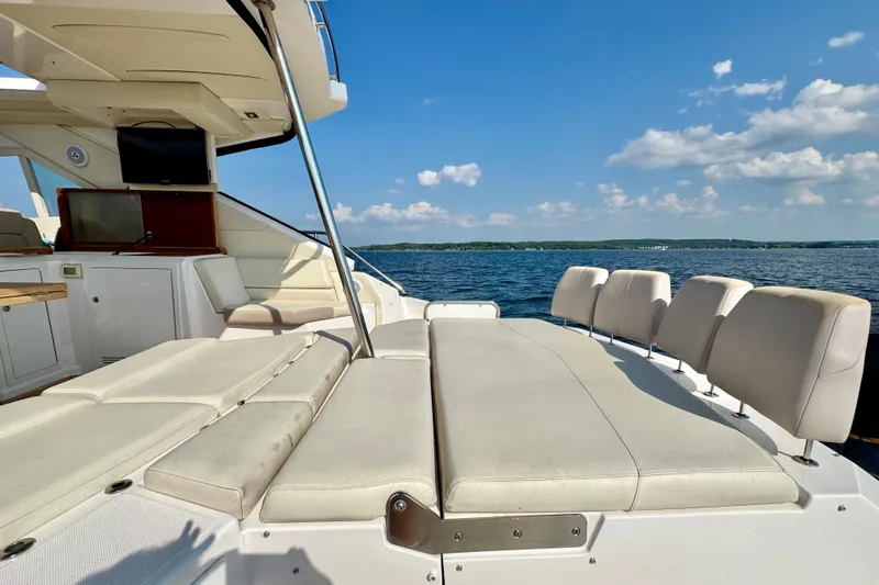 Makin' Waves II Yacht Photos Pics Luxurious 2011 Regal 52 Sport Coupe yacht interior with plush seating, overlooking serene waters.