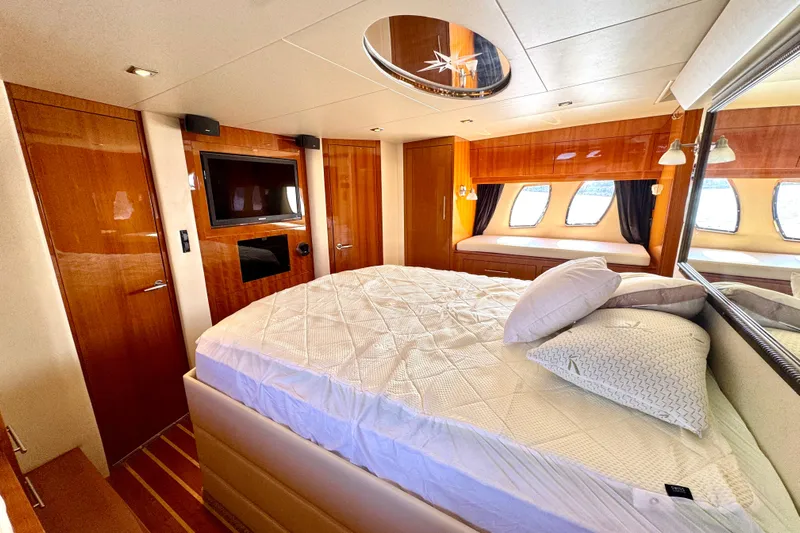Makin' Waves II Yacht Photos Pics Luxurious 2011 Regal 52 Sport Coupe yacht bedroom with elegant wood finishes and modern amenities.