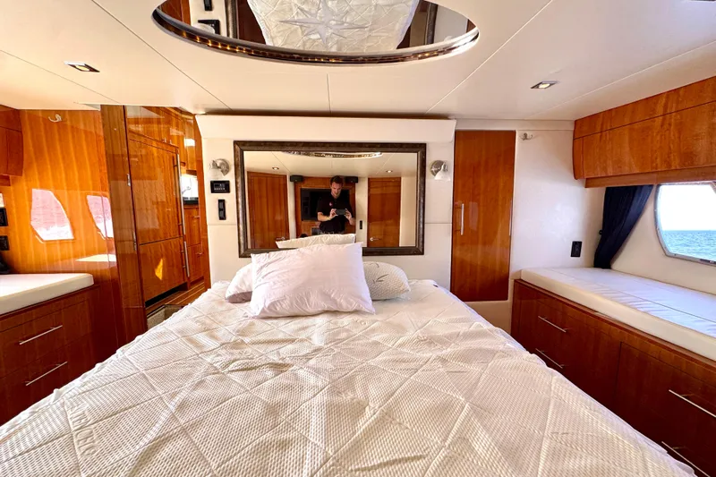 Makin' Waves II Yacht Photos Pics Luxurious bedroom interior of 2011 Regal 52 Sport Coupe yacht with elegant wood finishes.