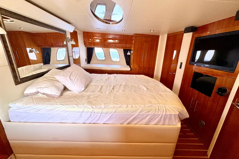 Makin' Waves II Yacht Photos Pics Luxurious bedroom interior of 2011 Regal 52 Sport Coupe yacht with elegant wood finishes.