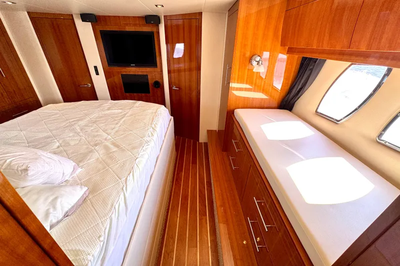 Makin' Waves II Yacht Photos Pics Luxurious cabin interior of 2011 Regal 52 Sport Coupe yacht with wood finishes and comfortable bedding.
