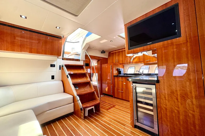 Makin' Waves II Yacht Photos Pics Luxurious interior of 2011 Regal 52 Sport Coupe yacht with wood finishes and modern amenities.