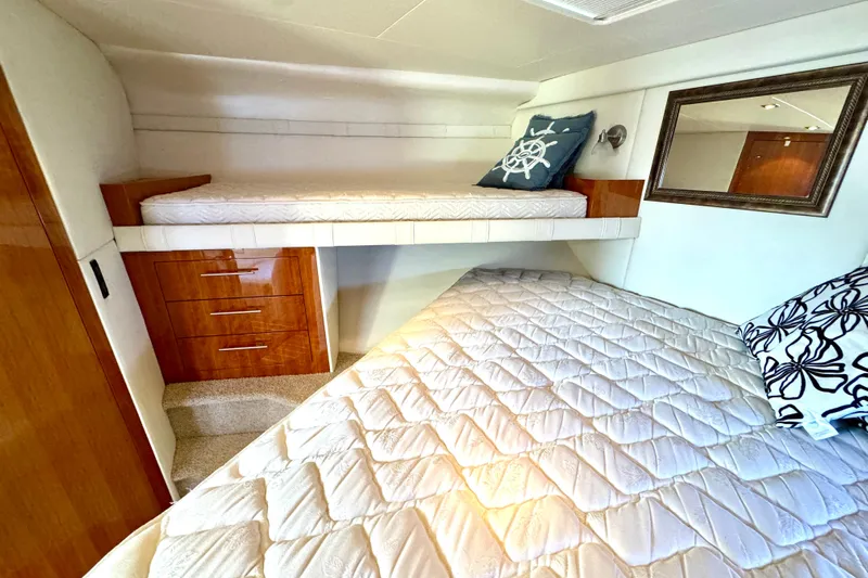 Makin' Waves II Yacht Photos Pics Interior cabin of 2011 Regal 52 Sport Coupe with bunk beds and wooden cabinetry.