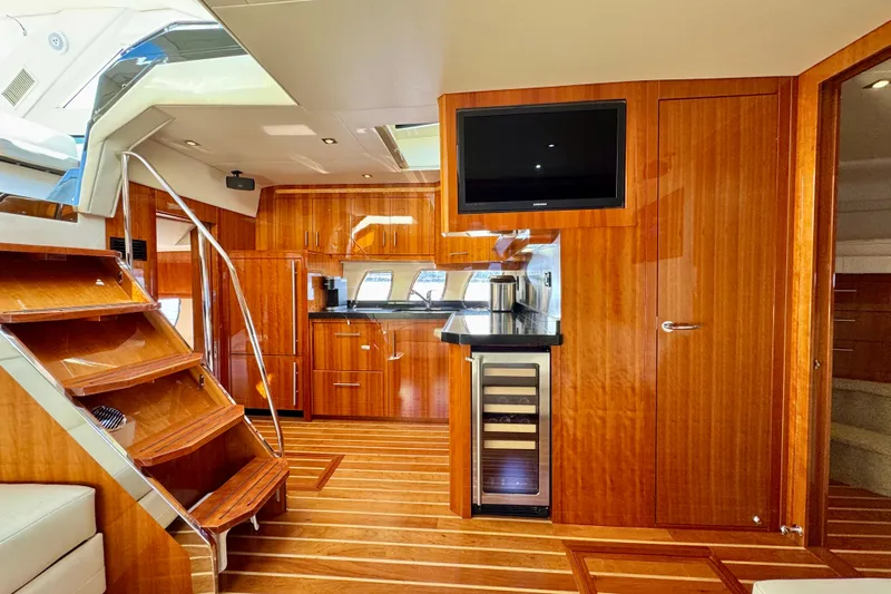 Makin' Waves II Yacht Photos Pics Luxurious interior of 2011 Regal 52 Sport Coupe yacht with wooden finishes and modern amenities.