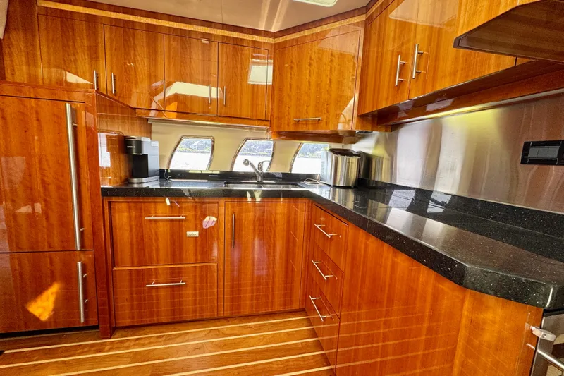 Makin' Waves II Yacht Photos Pics Luxurious 2011 Regal 52 Sport Coupe yacht kitchen with sleek wood cabinetry and modern appliances.