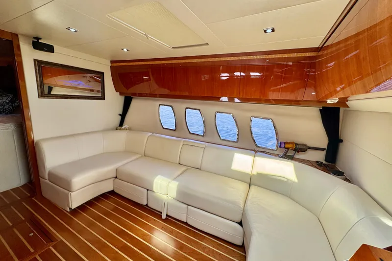 Makin' Waves II Yacht Photos Pics Luxurious interior of 2011 Regal 52 Sport Coupe yacht with white leather seating.