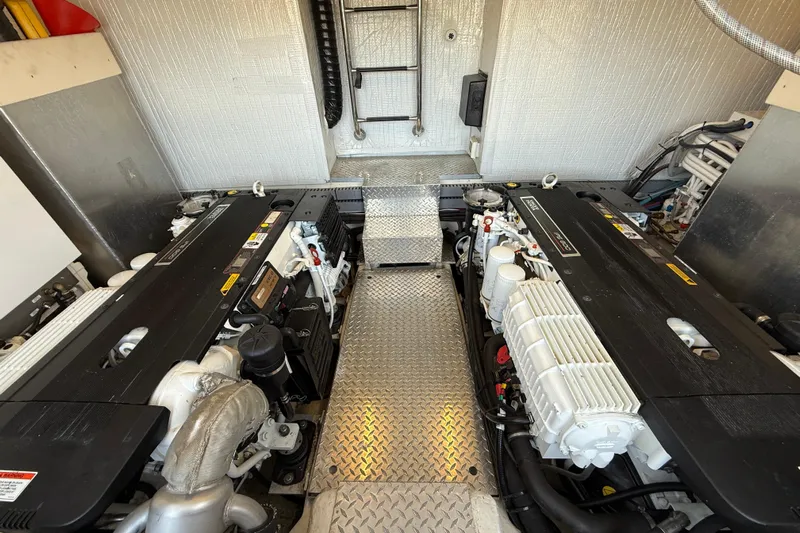 Makin' Waves II Yacht Photos Pics Engine room of 2011 Regal 52 Sport Coupe with dual engines and metallic flooring.