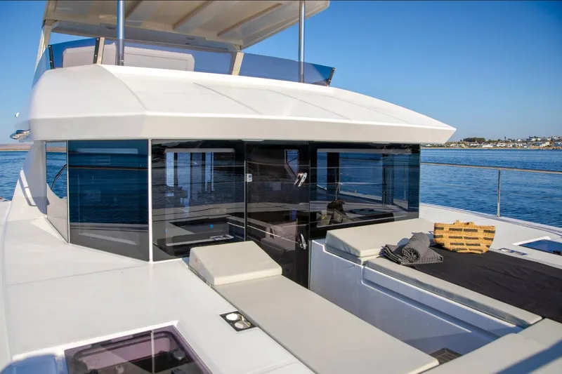  Yacht Photos Pics 2025 Leopard 40 Powercat yacht with sleek design and spacious deck on calm waters.
