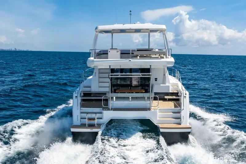  Yacht Photos Pics 2025 Leopard 40 Powercat cruising on open ocean under clear blue sky.